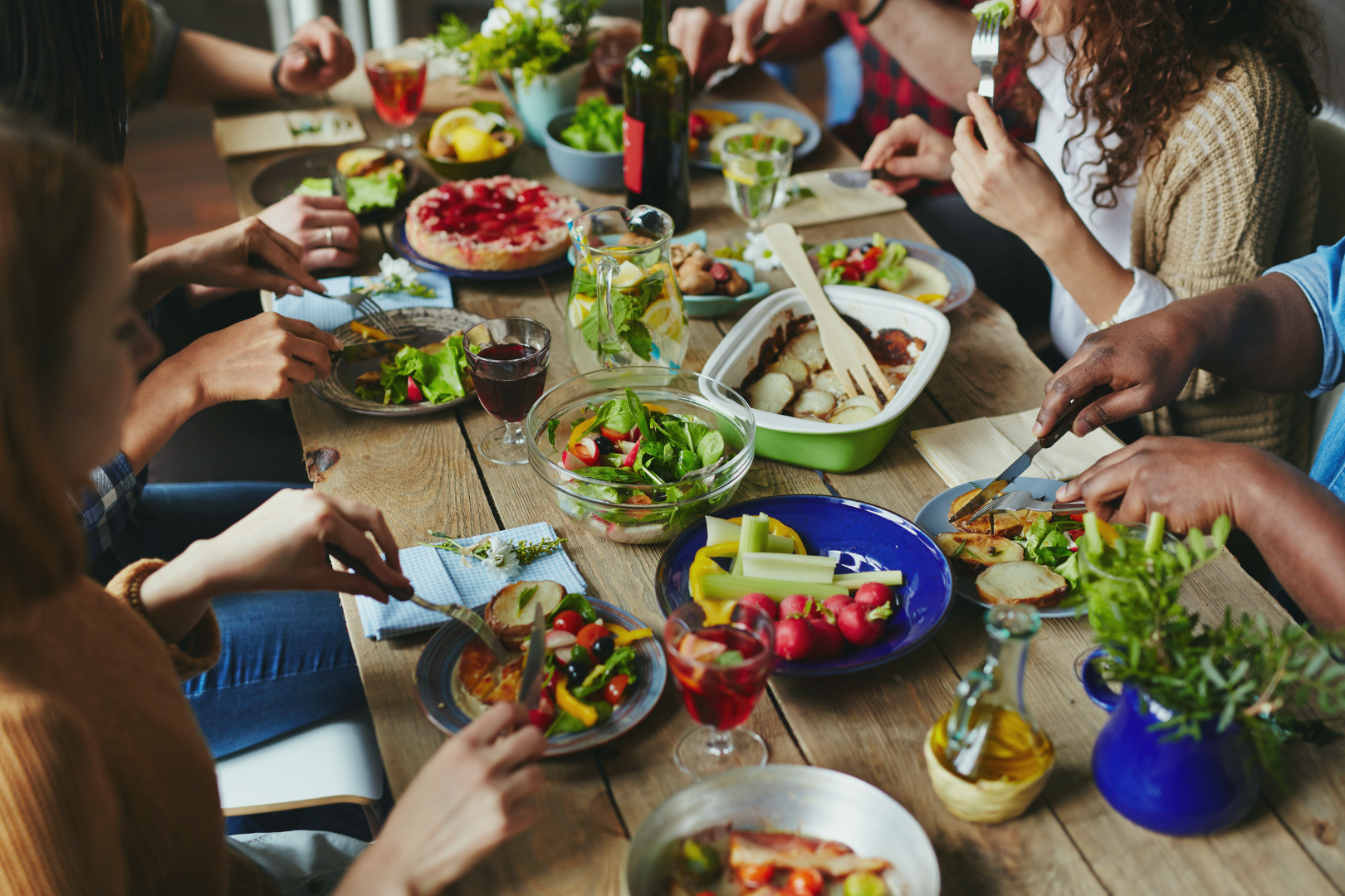 Friends and family sharing a meal at a dinner table